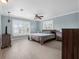 Spacious bedroom with light blue walls, white shutters and an inviting ceiling fan at 1105 Appleton Ave, Orlando, FL 32806