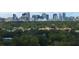 Scenic view of Orlando skyline beyond lush green trees, showcasing the downtown area at 1105 Appleton Ave, Orlando, FL 32806