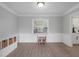 Dining Room featuring wainscoting, a window view, and light hardwood flooring at 1105 Appleton Ave, Orlando, FL 32806