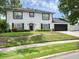 Two-story home featuring manicured lawn, driveway, and two-car garage at 1105 Appleton Ave, Orlando, FL 32806