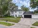 Two-story home featuring a manicured lawn, a driveway, and a two-car garage at 1105 Appleton Ave, Orlando, FL 32806