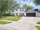 Two-story traditional home showcasing a well-manicured front yard and a two car garage at 1105 Appleton Ave, Orlando, FL 32806