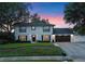 Charming two-story home with a well-manicured lawn and inviting curb appeal against a colorful dusk sky at 1105 Appleton Ave, Orlando, FL 32806