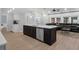 Modern kitchen with a kitchen island, stainless appliances, and open living area at 1105 Appleton Ave, Orlando, FL 32806