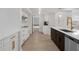 Well-lit kitchen with modern appliances, an island with seating and white cabinets at 1105 Appleton Ave, Orlando, FL 32806