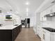 Bright kitchen featuring stainless steel appliances, an island with seating, and white cabinets at 1105 Appleton Ave, Orlando, FL 32806