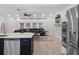 Open floor plan with stainless appliances, kitchen island, and a living room with a leather sofa at 1105 Appleton Ave, Orlando, FL 32806