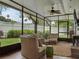 Inviting screened-in patio with comfortable seating and a ceiling fan at 1105 Appleton Ave, Orlando, FL 32806