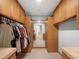 Spacious walk-in closet with custom wood cabinets and shelves for ample storage at 1105 Appleton Ave, Orlando, FL 32806