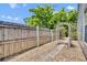 Fenced backyard with a stone paver pathway and lovely garden at 1117 Park Green Pl, Winter Park, FL 32789