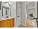 This bathroom has a wood vanity, framed mirror and tile floors with an open doorway at 1117 Park Green Pl, Winter Park, FL 32789