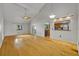 Spacious living room with hardwood floors, vaulted ceilings, and natural light, open to kitchen at 1117 Park Green Pl, Winter Park, FL 32789