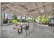 Outdoor patio with picnic tables and bench seating offers a shaded area surrounded by greenery at 1117 Park Green Pl, Winter Park, FL 32789