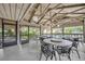 Open patio features multiple seating options, ceiling fans, and a view of the surrounding green space at 1117 Park Green Pl, Winter Park, FL 32789