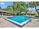 Community pool surrounded by mature trees, chairs and a sundeck at 1117 Park Green Pl, Winter Park, FL 32789