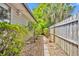 Landscaped side yard with stone pavers, privacy fence, and established plants at 1117 Park Green Pl, Winter Park, FL 32789