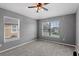 A carpeted bedroom showcases natural light through two windows and a ceiling fan for added comfort at 1210 San Jacinto Cir, Sanford, FL 32771