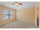 Cozy bedroom with neutral carpet, a ceiling fan, and a window offering natural light at 1210 San Jacinto Cir, Sanford, FL 32771