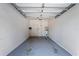 This is an empty two car garage with a water heater and access door at 1210 San Jacinto Cir, Sanford, FL 32771