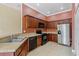 Well-equipped kitchen with stainless steel appliances, dark cabinets, and tile flooring at 1210 San Jacinto Cir, Sanford, FL 32771