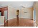Spacious living area with wood floors, ceiling fan, and a pass-through to the kitchen at 1210 San Jacinto Cir, Sanford, FL 32771