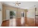 Bright living room with wood floors, ceiling fan, and sliding glass doors to the outdoor space at 1210 San Jacinto Cir, Sanford, FL 32771
