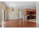 Open-concept living space with a dining area, kitchen with dark cabinets, and a sliding glass door at 1210 San Jacinto Cir, Sanford, FL 32771