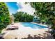 Community pool with lounge chairs and lush landscaping at 1210 San Jacinto Cir, Sanford, FL 32771