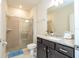 Modern bathroom featuring a glass-enclosed shower and granite vanity at 1292 Blue Island Dr, Clermont, FL 34714