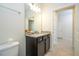 Bathroom featuring a granite vanity, framed mirror, and neutral color scheme at 1292 Blue Island Dr, Clermont, FL 34714
