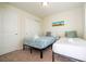 Cozy bedroom features two twin beds, neutral decor, and ample natural light at 1292 Blue Island Dr, Clermont, FL 34714