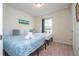 Cozy bedroom featuring two twin beds, bright walls, and a window providing natural light at 1292 Blue Island Dr, Clermont, FL 34714