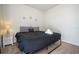 Comfortable bedroom with black bedspread, stylish headboard, and decorative bedside table at 1292 Blue Island Dr, Clermont, FL 34714