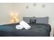 Comfortable bedroom with black bedspread, striped headboard, and stylish decor at 1292 Blue Island Dr, Clermont, FL 34714