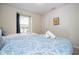 Bedroom featuring two beds, natural light, and a cartoon wall art at 1292 Blue Island Dr, Clermont, FL 34714