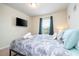 This cozy bedroom has a TV and window for natural light, creating a welcoming space at 1292 Blue Island Dr, Clermont, FL 34714
