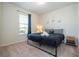 Comfortable bedroom with a queen bed, stylish decor, and natural light at 1292 Blue Island Dr, Clermont, FL 34714