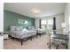 Bright bedroom featuring two beds, a desk, neutral carpet, and ample natural light from the window at 1292 Blue Island Dr, Clermont, FL 34714
