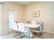 Dining room with a modern white table, stylish chairs, and natural light from the sliding glass door at 1292 Blue Island Dr, Clermont, FL 34714
