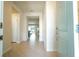 Inviting entryway with neutral tile flooring and view into the open floor plan of the home at 1292 Blue Island Dr, Clermont, FL 34714