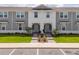 Attractive townhome with gray siding and a manicured lawn in a desirable location at 1292 Blue Island Dr, Clermont, FL 34714