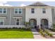 Charming townhome with well-manicured lawn and flowerbeds leading to the front entrance at 1292 Blue Island Dr, Clermont, FL 34714