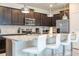 Beautiful kitchen with granite countertops, stainless steel appliances, and a breakfast bar with modern seating at 1292 Blue Island Dr, Clermont, FL 34714