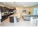 Open concept kitchen featuring an island with bar seating and stainless steel appliances at 1292 Blue Island Dr, Clermont, FL 34714