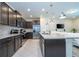 Spacious kitchen with stainless steel appliances, granite countertops, and center island with bar seating at 1292 Blue Island Dr, Clermont, FL 34714