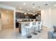 Well-lit kitchen with granite countertops, stainless steel appliances, and bar-style seating at the island at 1292 Blue Island Dr, Clermont, FL 34714