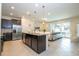 Open concept kitchen with a center island and easy access to the living room and outdoor patio at 1292 Blue Island Dr, Clermont, FL 34714