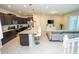 Open concept kitchen featuring an island with bar seating and stainless steel appliances at 1292 Blue Island Dr, Clermont, FL 34714