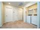 Bright laundry room with a washer, dryer, shelving, and multiple storage closets at 1292 Blue Island Dr, Clermont, FL 34714