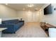 Modern living area with plush sofa, TV, side table, and neutral decor at 1292 Blue Island Dr, Clermont, FL 34714